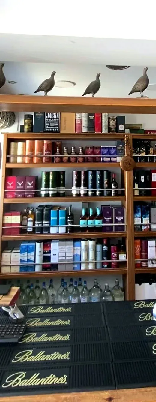 Spirits shelves behind the counter in Argostoli, Kefalonia