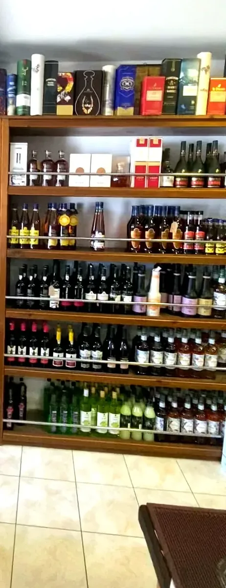 Floor-to-ceiling wooden shelves of wines and spirits